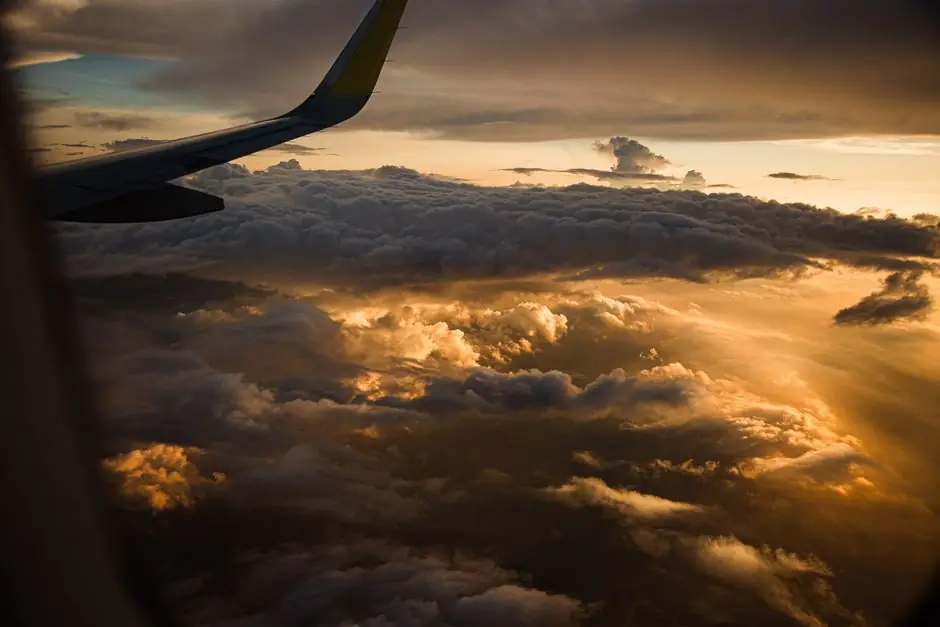 Aircraft wing above the clouds on approach to a New York airport