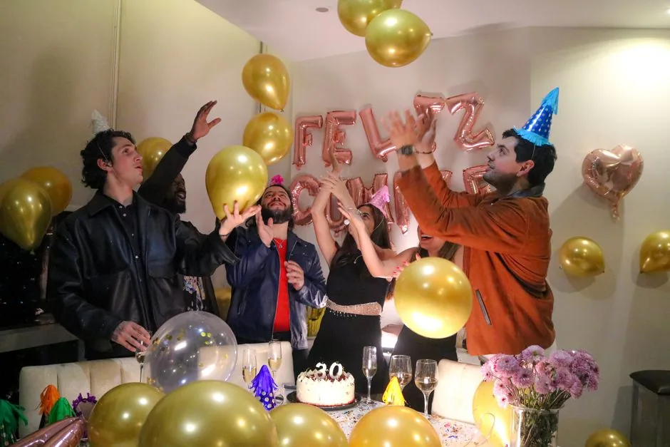 Friends celebrating a thirtieth birthday with gold balloons