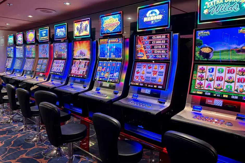 Row of slot machines with colorful screens