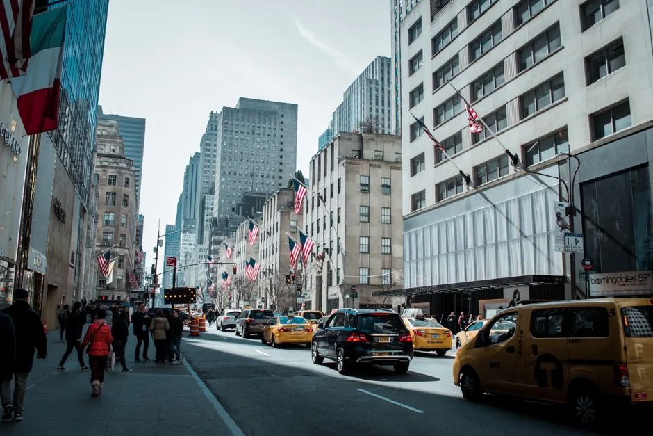Busy Manhattan street with yellow cabs and shoppers