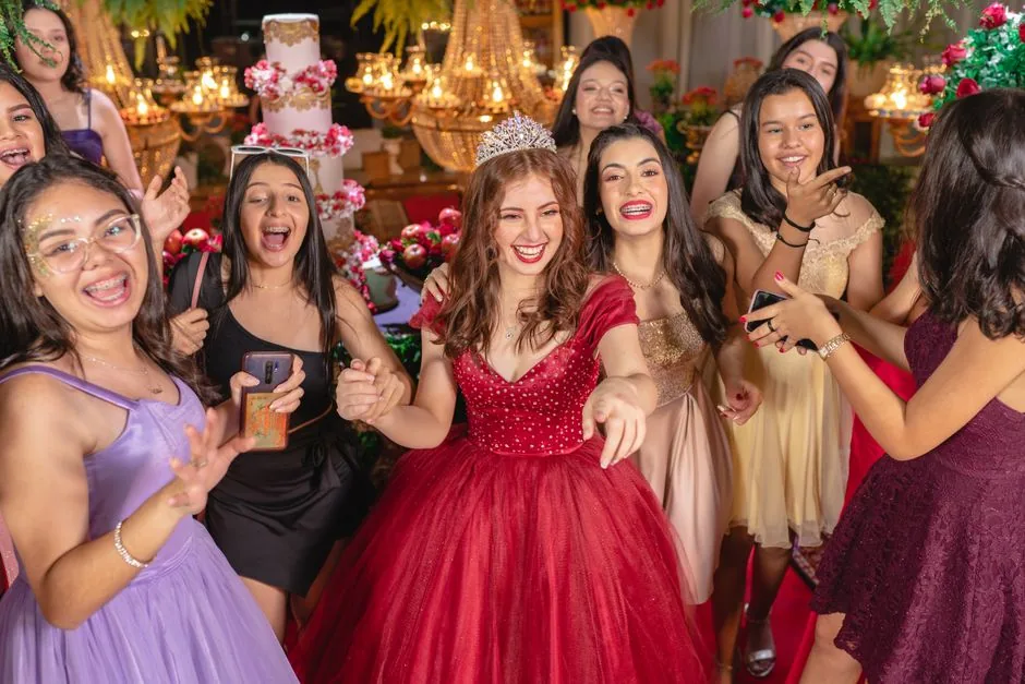 Friends in formal dresses laughing together at a party