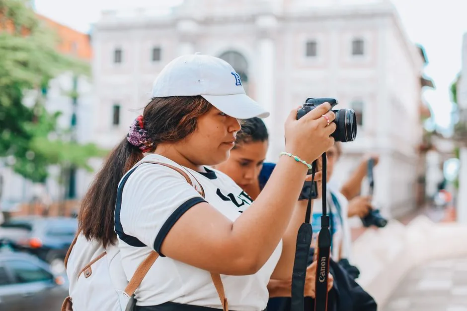 Young woman taking photographs with a camera outdoors